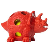 Red plastic paws dinosaur toy stress ball shaped like a triceratops with raised rubber pimples and yellow inner balls