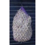 Purple mesh hungry horace greedy feeder haynet filled with dry straw hanging against dark background