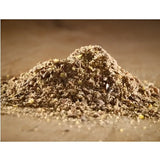 A mound of brown granular cooked linseed meal with specks used as fish bait from hutton mill