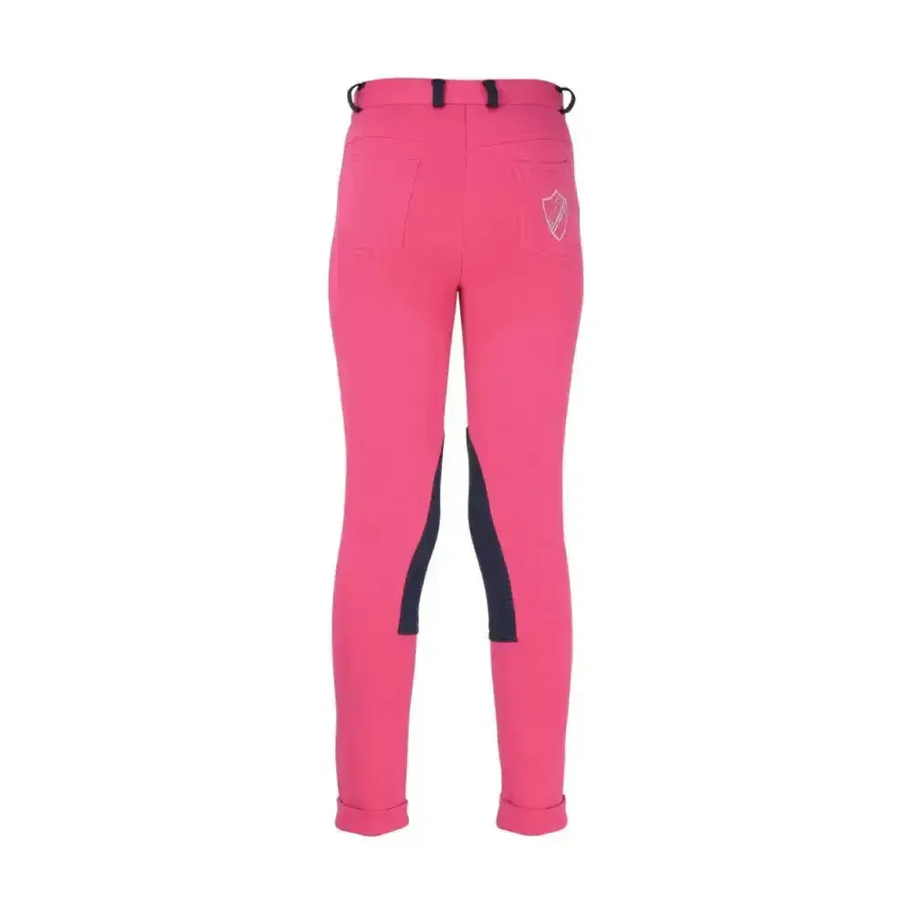 Back view of bright pink hy equestrian belton children’s jodhpurs with black side panels and shield logo on pocket