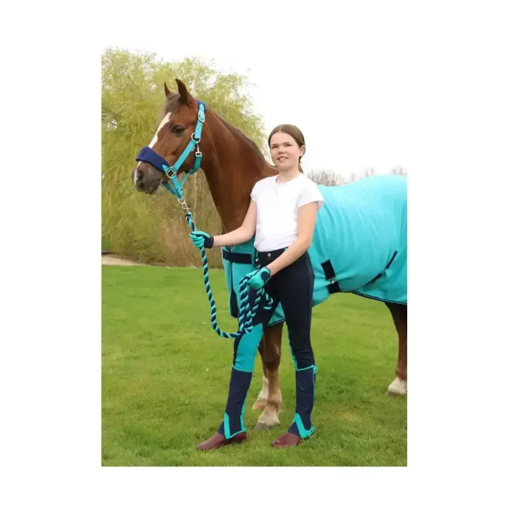 Teal and navy horse blanket with black straps shown with equestrian belton children’s riding gloves for kids use