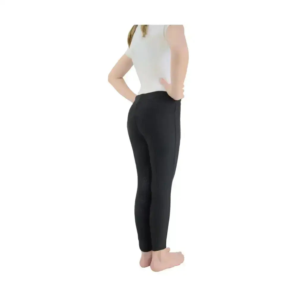 Black, form-fitting equestrian blizzard children’s softshell riding tights with smooth stretchy material and high waistband