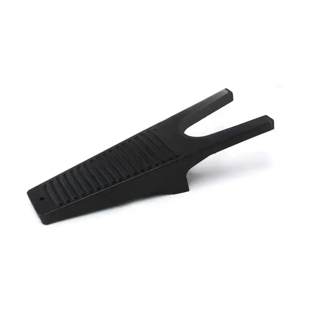 Black plastic equestrian boot jack with textured ribbed surface and two prongs for removing muddy boots easily