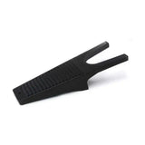 Black plastic equestrian boot jack with textured ribbed surface and two prongs for removing muddy boots easily
