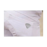 A sparkling diamond-shaped brooch with clear rhinestones pinned on white fabric of hy equestrian cadiz mizs competition breeches