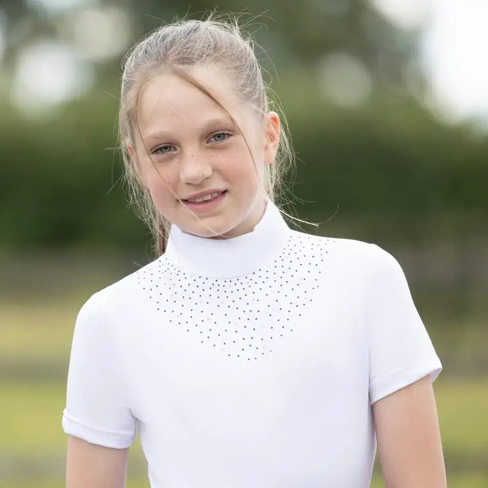 White short-sleeved equestrian children’s roka regal top with high collar and black dot details on neckline