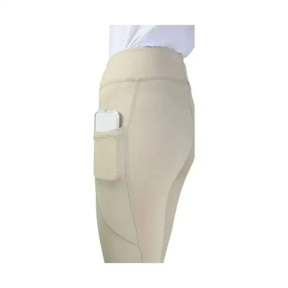 Beige hy equestrian childrens selah competition riding tights with high waist and side pocket holding smartphone