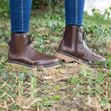 Brown leather staden chelsea boot with side zipper and mesh panels worn with blue jeans for equestrian children’s use