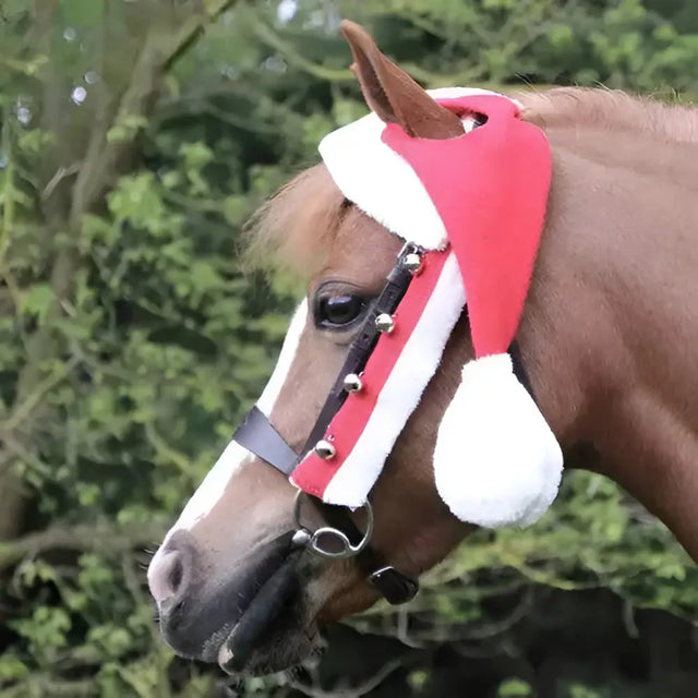 A festive red and white hy equestrian christmas santa horse hat with fluffy trim designed to fit over a horse’s head
