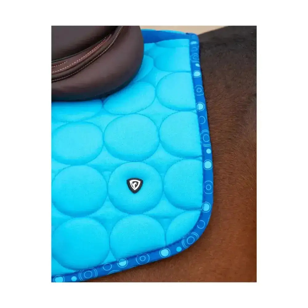 Bright blue quilted Hy Equestrian dynamizs ecliptic close contact saddle pad with circular padding and decorative border