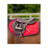 Red quilted close contact saddle pad with dark blue border and floral pattern from equestrian dynamizs ecliptic