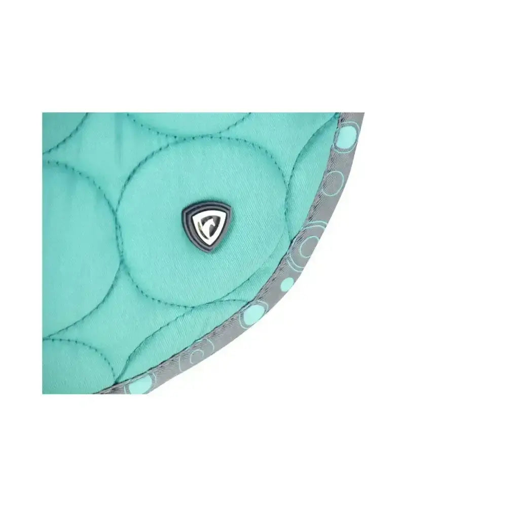 Teal quilted fabric with circular stitching and gray trim with light teal dots on the equestrian dynamizs ecliptic close contact saddle pad