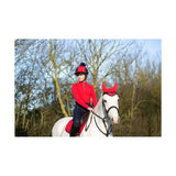Red equestrian helmet with black brim and blue pom-pom featuring hy equestrian dynamizs ecliptic fly veil close-knit crochet design
