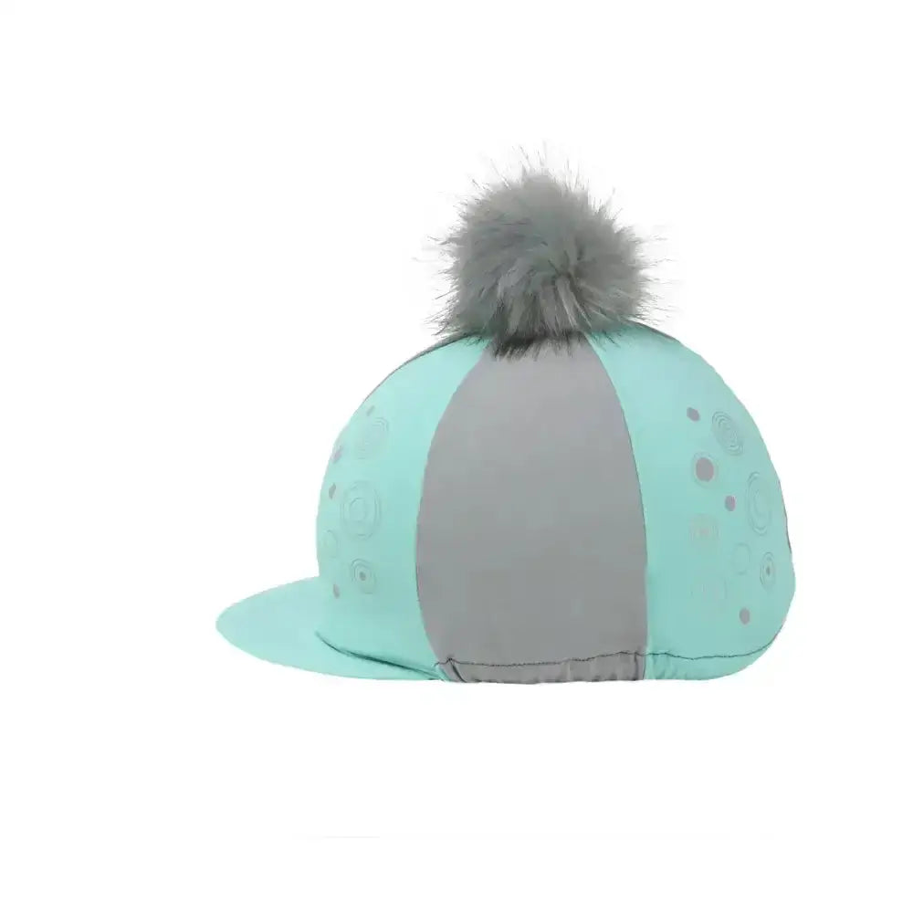 A mint green and gray equestrian dynamizs ecliptic hat cover with a fluffy gray pom-pom on top