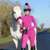 Pink riding suit with teal accents and matching helmet featuring equestrian dynamizs ecliptic riding tights plum teal