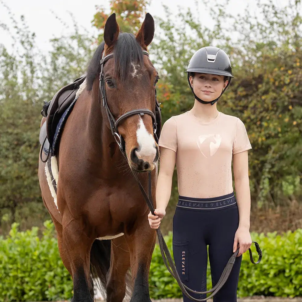 Black equestrian helmet with sleek modern design and silver accent paired with hy equestrian elevate allure mizs t-shirt