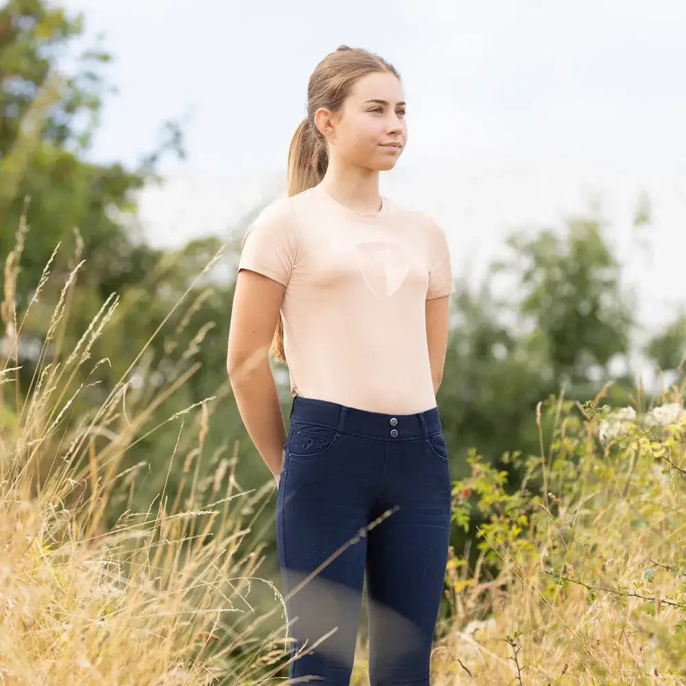 A pair of navy blue fitted riding pants with button closures matching the equestrian elevate allure mizs t-shirt collection
