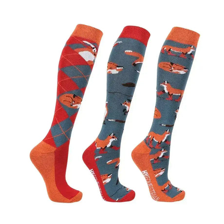 Three pairs of hy equestrian frivolous fox socks in orange and gray with fox designs and an argyle pattern