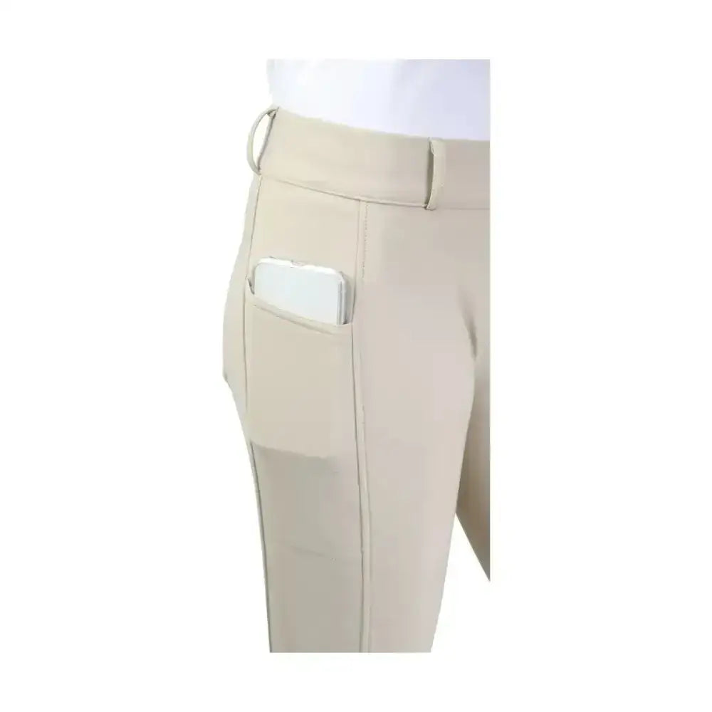 Beige hy equestrian glacial softshell riding tights with sleek design and side pocket holding a smartphone
