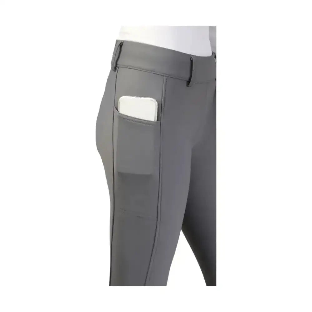 Gray equestrian glacial softshell riding tights with sleek fit and side pocket holding a white smartphone