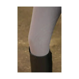 A pair of light gray sheer hy equestrian glacial softshell riding tights worn with a black boot showing brushed fleece lining