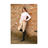 White long-sleeved turtleneck top paired with equestrian glacial softshell riding tights featuring brushed fleece lining