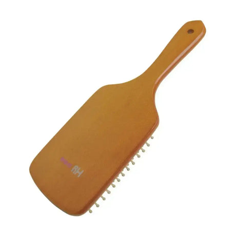 A sleek amber plastic paddle brush with white bristles and a hole at the handle in hy equestrian luxury wooden mane collection