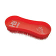 Red plastic equestrian miracle grooming brush with dense stiff bristles and molded handle with hu shine logo