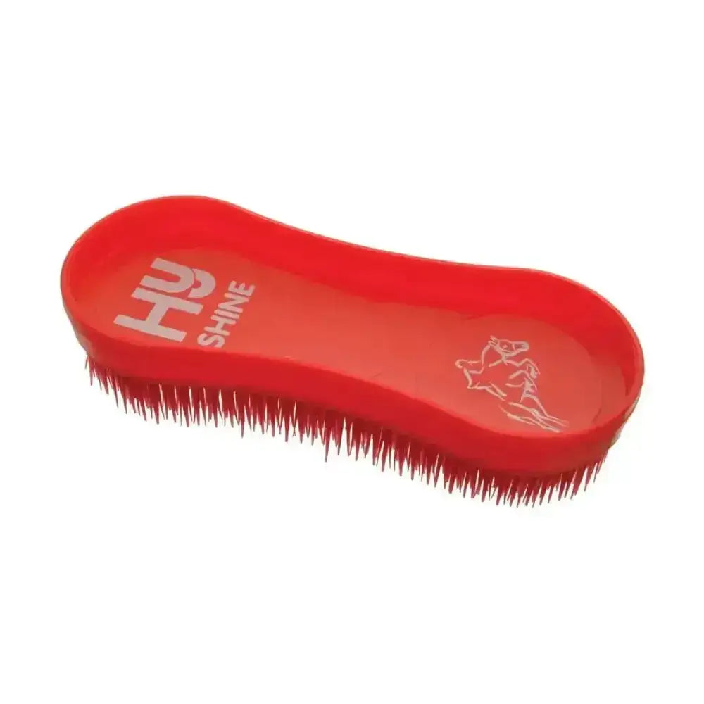 Red plastic horse brush with stiff bristles and molded handle branded hu shine from equestrian miracle grooming brushes