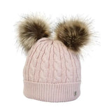 A soft pink cable-knit equestrian morzine children’s bobble hat with two fluffy brown faux fur pom-poms on top