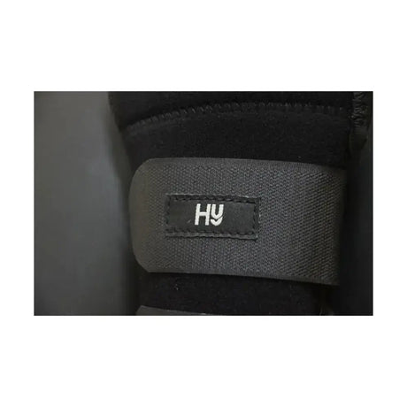 Black fabric strap with stitched hy logo on equestrian neoprene protect tail shock-absorbing tail guard