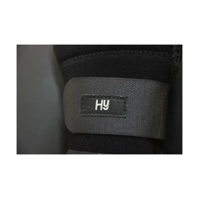 Black fabric strap with stitched hy logo on equestrian neoprene protect tail shock-absorbing tail guard