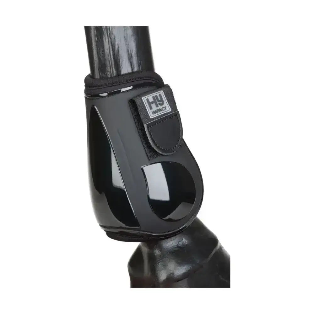 Black glossy plastic hy equestrian pro fetlock boots with black fabric strap and hy impact logo patch for quality performance boots