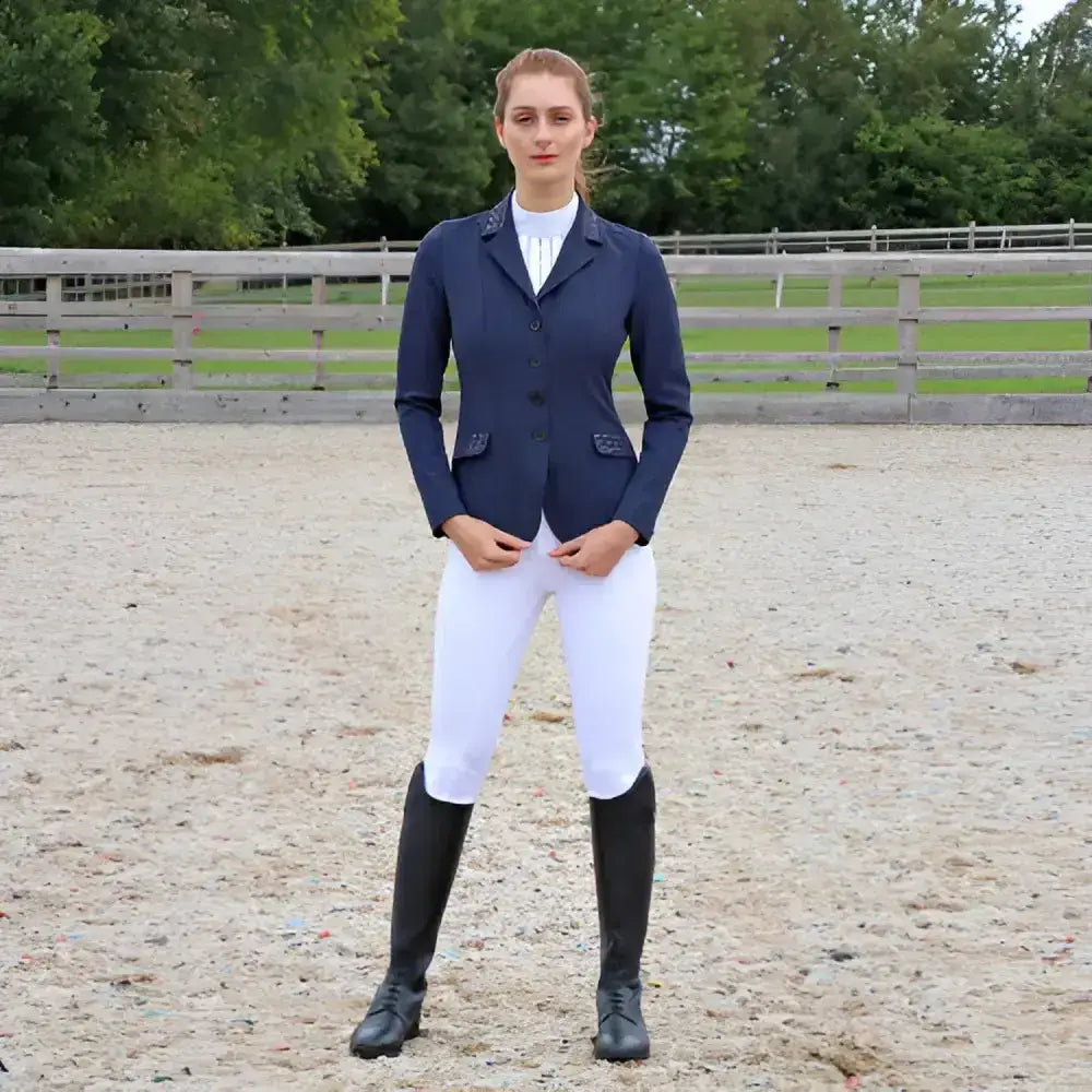 Navy blue hy equestrian jacket with black buttons and silver stud pockets paired with roka rose breeches