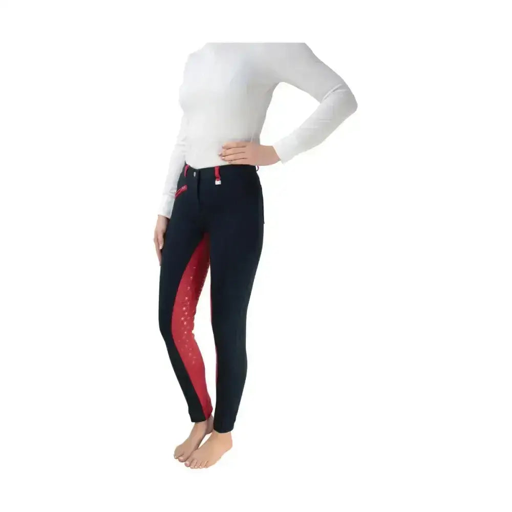 Black equestrian saxby silicone jodhpurs with red dotted side panels and matching red zipper accents for everyday use