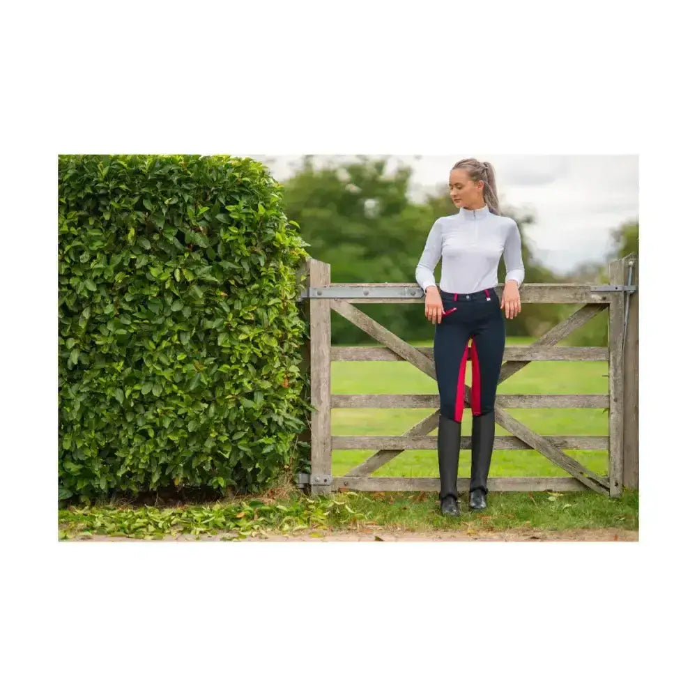 Navy blue equestrian saxby silicone jodhpurs with red side panels and subtle logo on left thigh for everyday riding