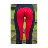 Back view of red and navy blue equestrian saxby silicone jodhpurs with honeycomb pattern on silicone back panel