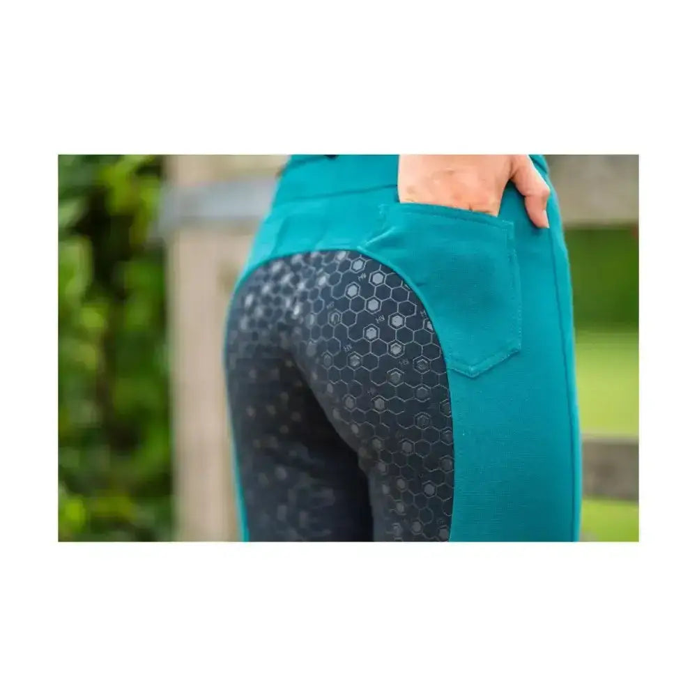 Teal and dark gray honeycomb patterned equestrian saxby silicone jodhpurs with a solid teal waistband for everyday riding