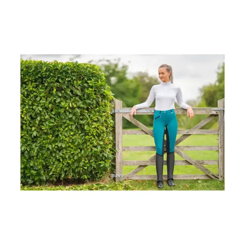 Teal equestrian saxby silicone jodhpurs with black side panels and zipper waist for everyday riding comfort
