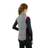 Gray and pink hy equestrian silva flash two tone reflective gilet worn over black long sleeves for riding comfort