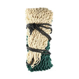 Beige and green knitted mesh equestrian slow flow haynet tied with black rope for slow hay consumption