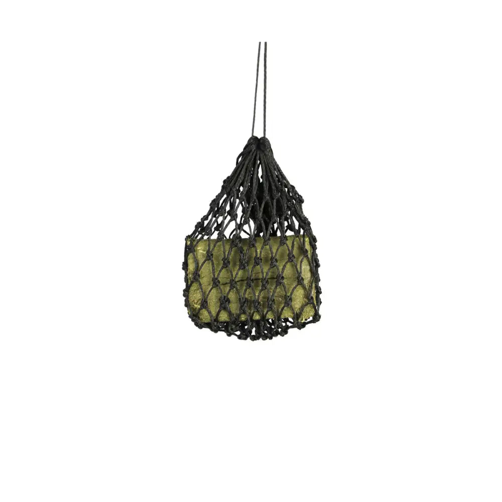 Black macrame slow flow snack haynet holding green glass forage block for equestrian slow flow feeding