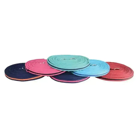 A set of colorful navy blue pink teal light blue and red equestrian soft webbing lunge reins made of coiled foam mats