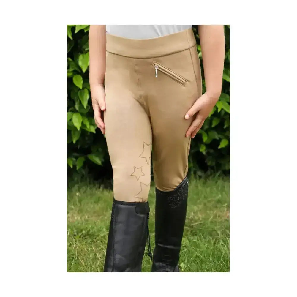 Tan equestrian stella children’s riding tights with subtle star pattern and zippered side pocket for comfort and style