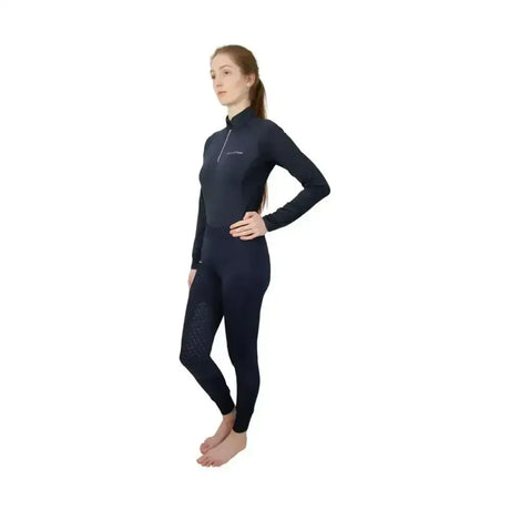 Black long-sleeved equestrian synergy base layer with high collar zipper and perforated detailing on legs for athletes