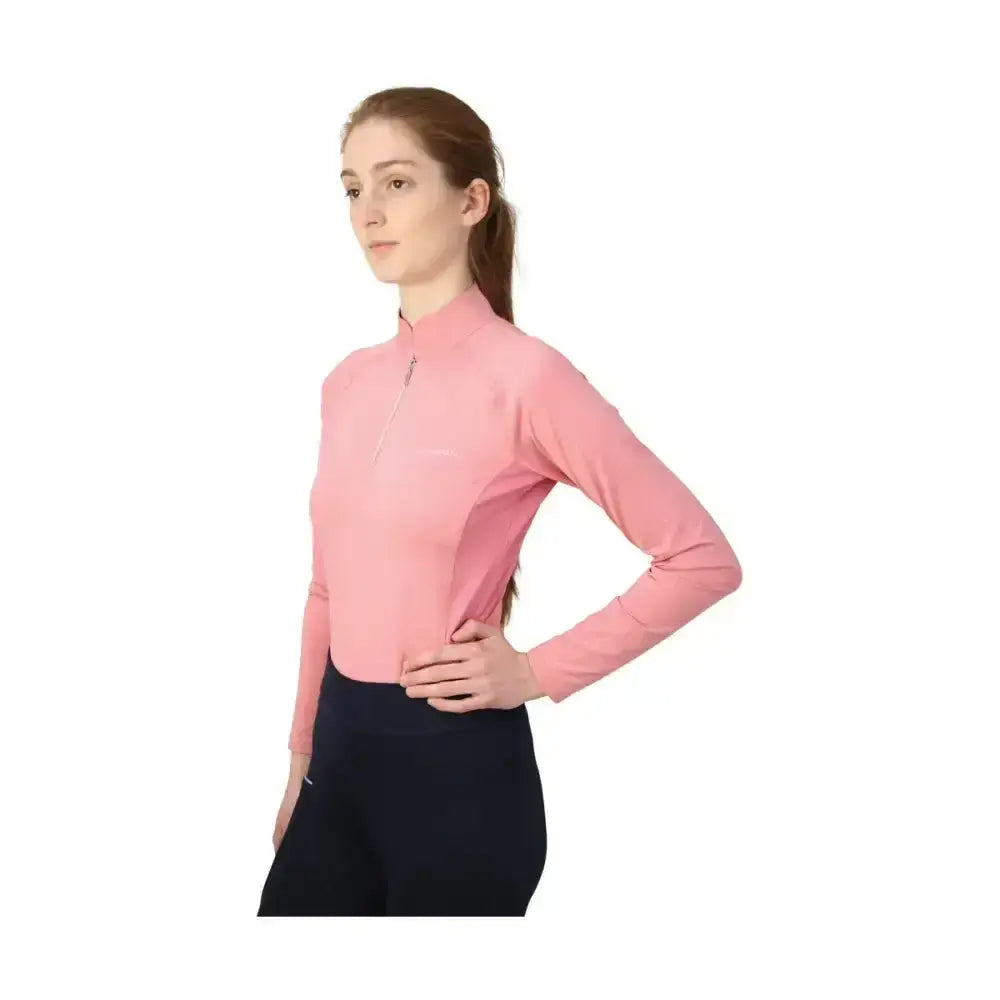 A soft pink long-sleeved athletic top with high collar and zipper front in hy equestrian synergy base layer for equestrian athlete