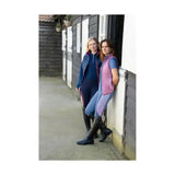 Pink quilted vest with purple zipper and trim worn over blue synergy elevate polo with specialised moisture wicking tech