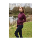 A maroon hy equestrian synergy flex jacket with high collar and subtle white zipper accents for excellent 4-way flexibility