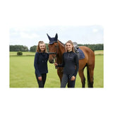 Brown horse wearing a navy blue hy equestrian synergy fly veil ear cover and saddle pad for fly protection