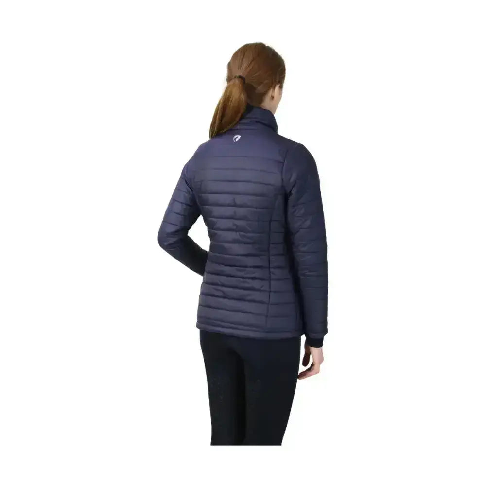 Navy blue quilted fabric with high collar and subtle logo on shoulder on the equestrian synergy padded jacket